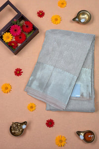Gray saree with a border on a beige background with decorative elements