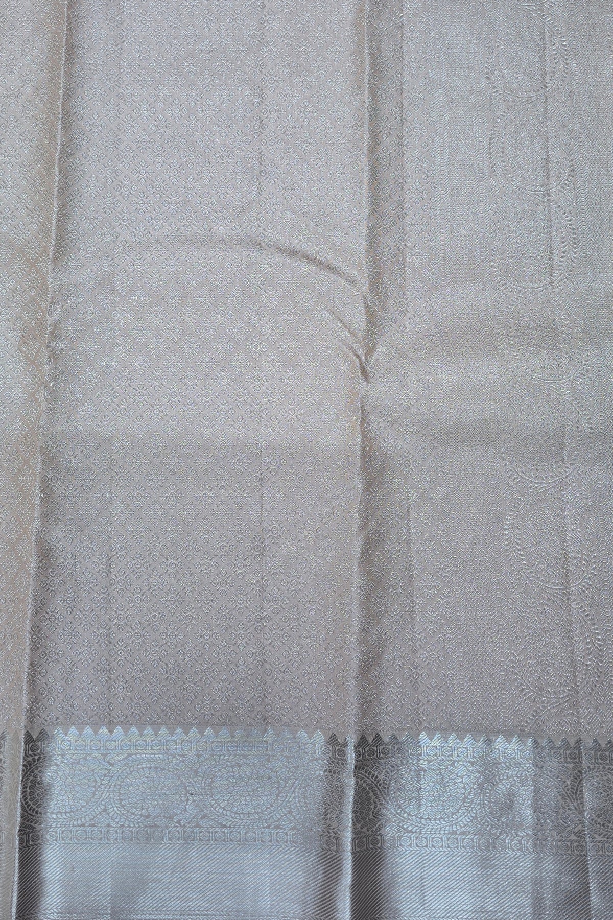 Close-up of a gray fabric with a subtle pattern and a blue border.