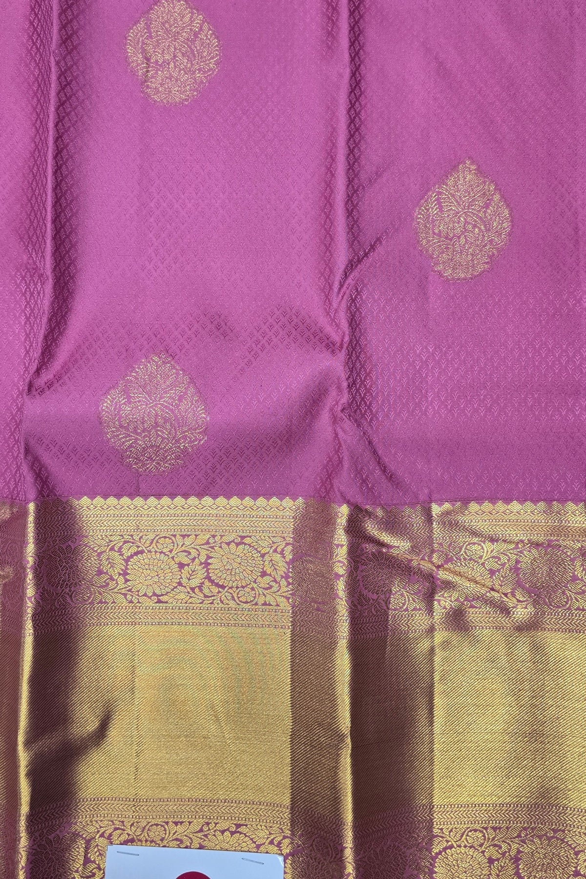 Purple fabric with gold patterns and a checkered border