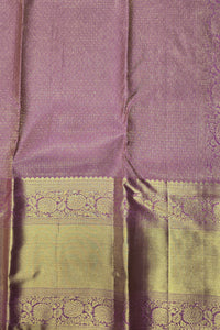 Close-up of a purple and green fabric with intricate patterns