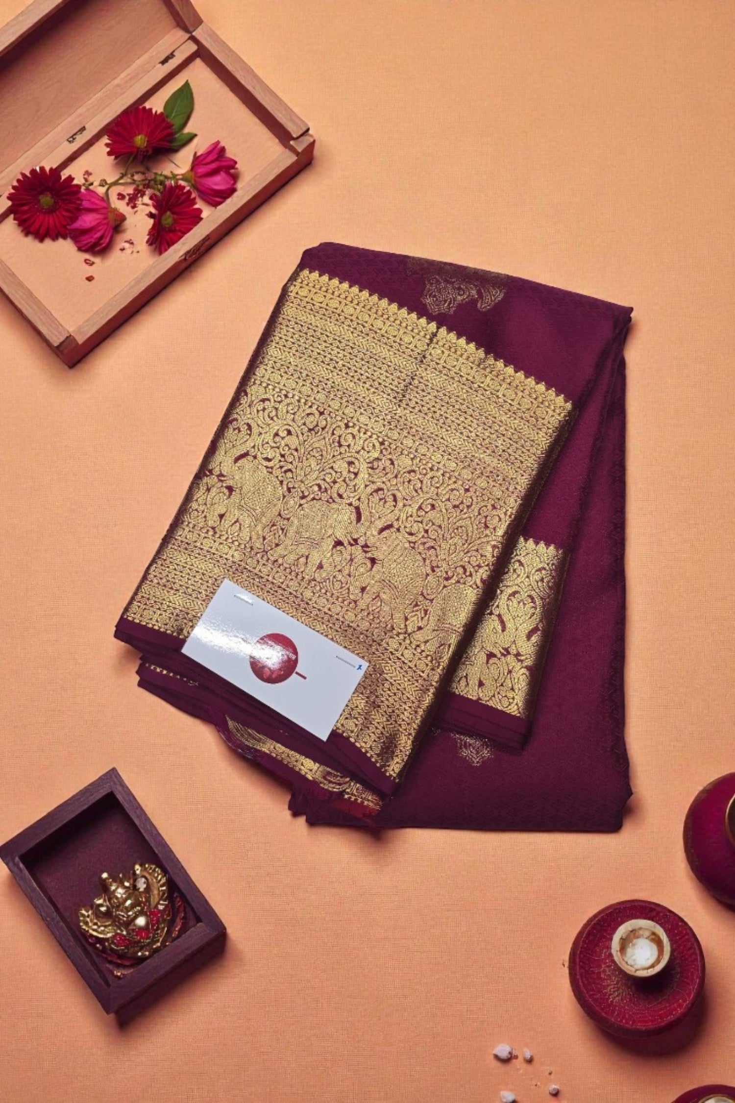 Decorative purple fabric with gold embroidery on a peach background