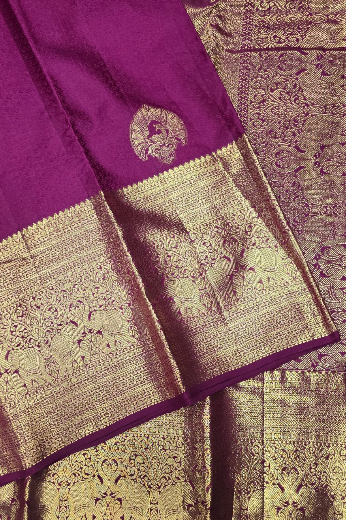Purple and gold saree with intricate patterns