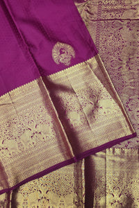 Purple and gold saree with intricate patterns