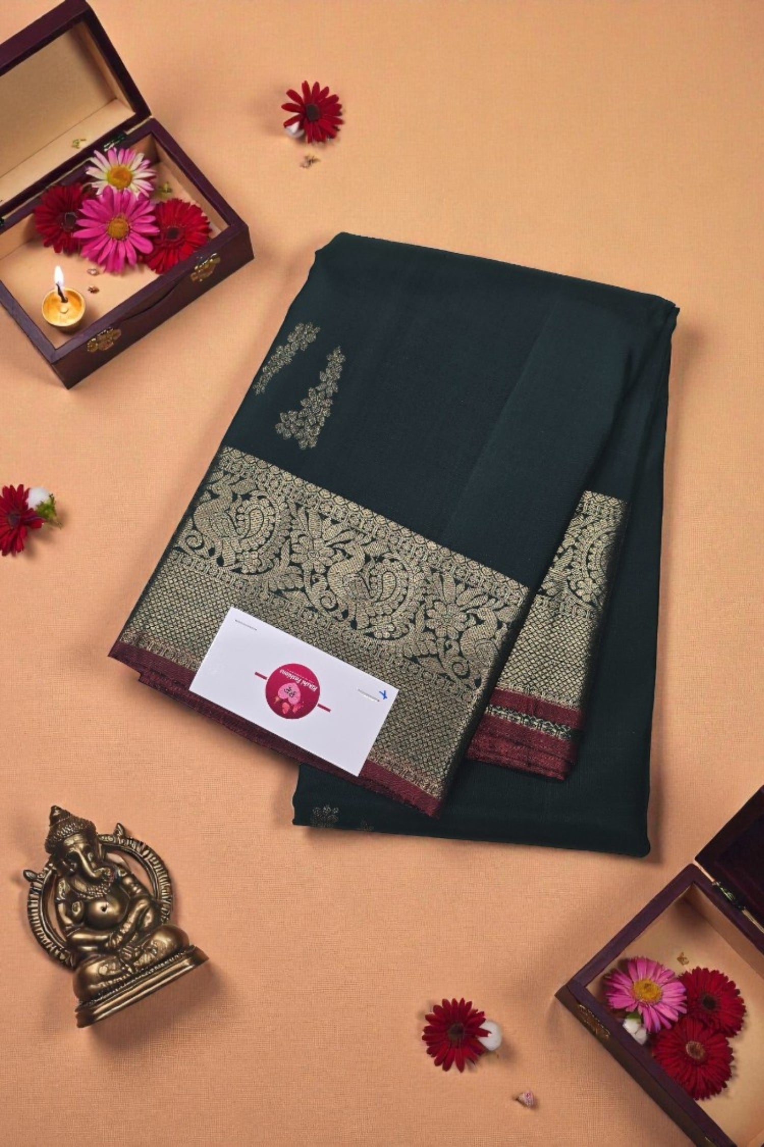Dark green saree with gold border on a beige background with decorative elements.