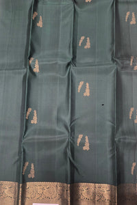 Dark green fabric with gold embroidery patterns