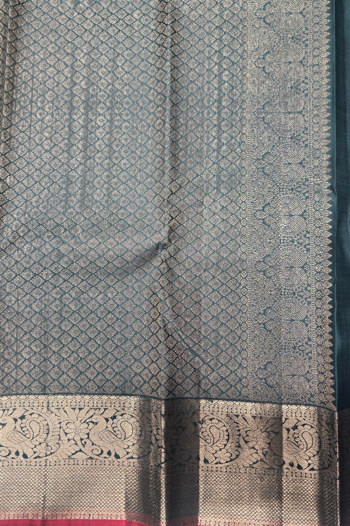Textured fabric with intricate patterns and a decorative border.