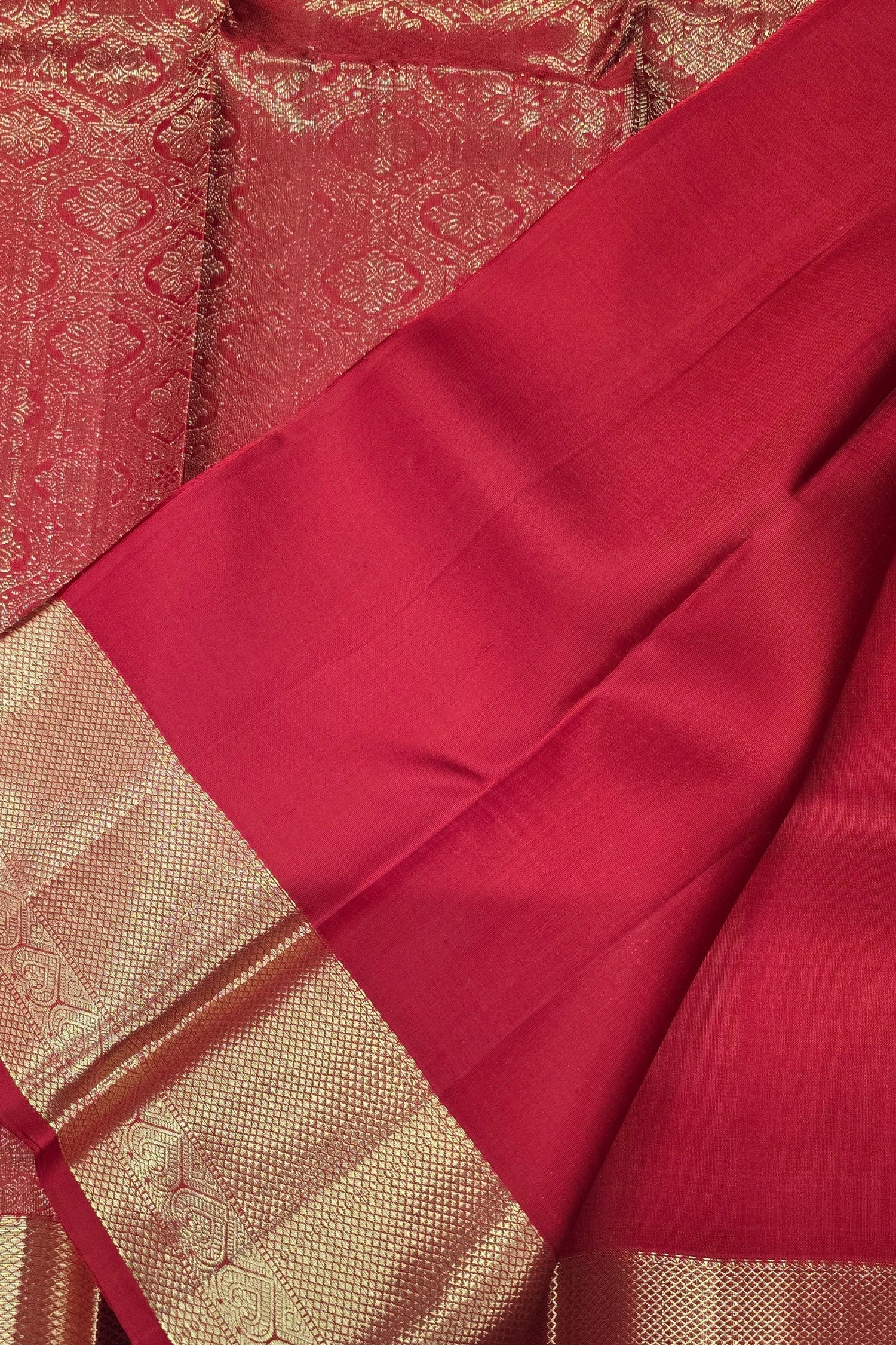 Red fabric with gold border and intricate patterns
