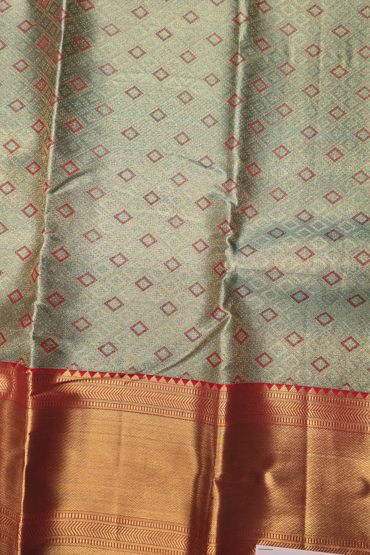 Fabric with a geometric pattern and a brown border