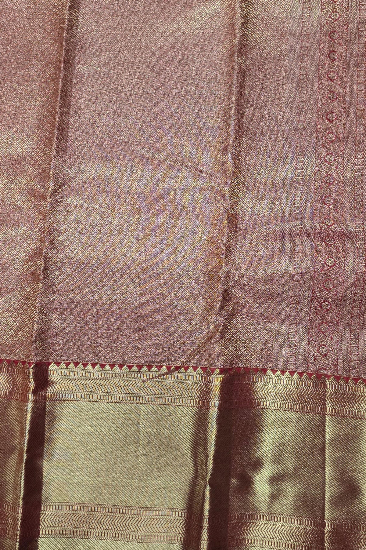 Close-up of a fabric with a checkered pattern and decorative border.