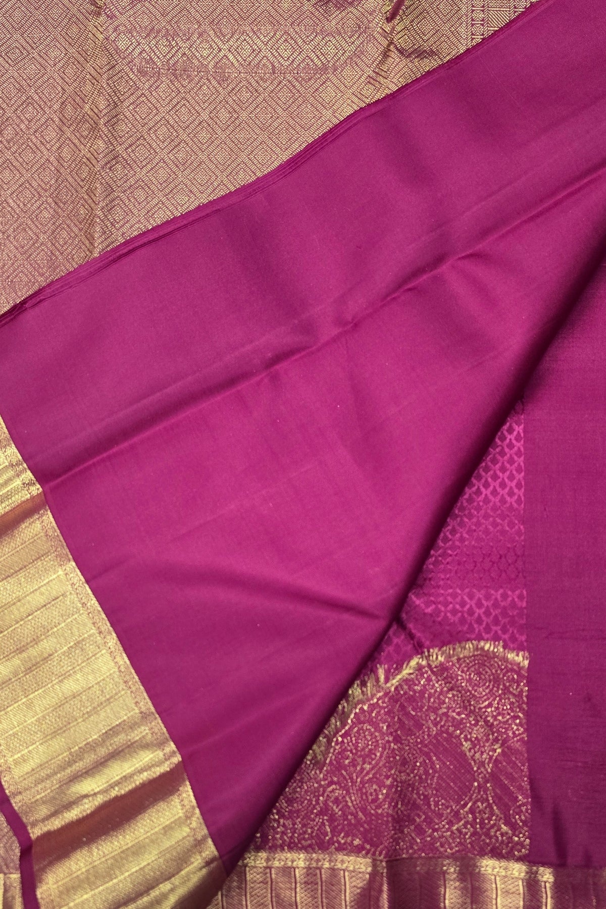 Purple fabric with gold border on a textured background