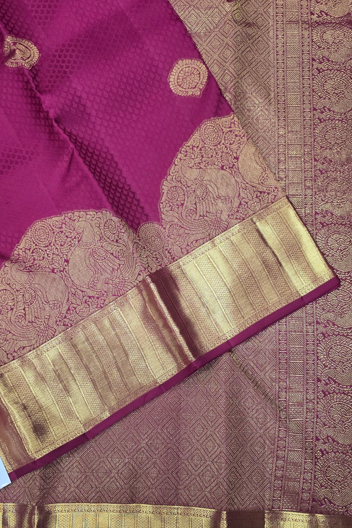 Purple saree with gold border and patterns