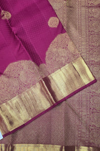 Purple saree with gold border and patterns