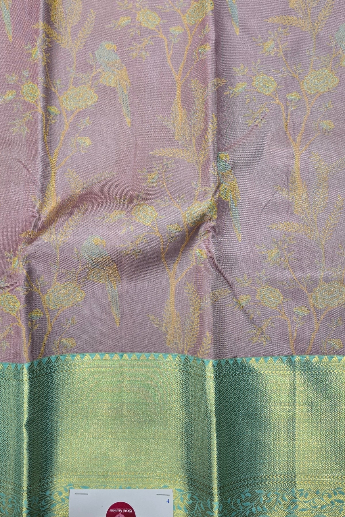 Fabric with floral pattern and green border on a pink background