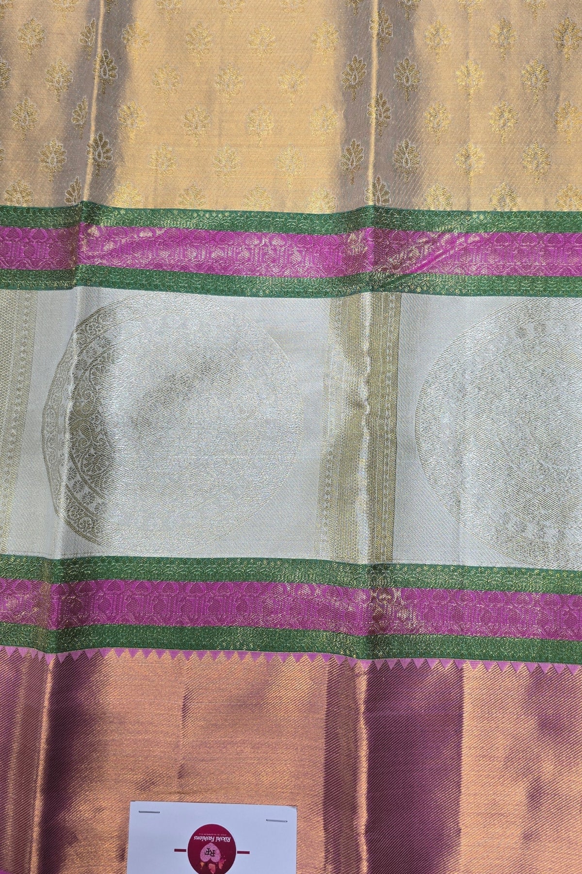 Close-up of a traditional fabric with pink and green borders