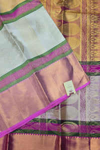Saree with pink and green border on a textured fabric background