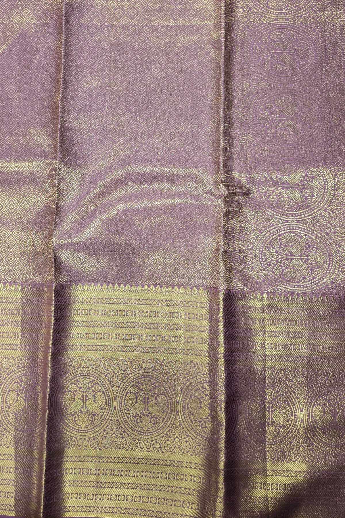 Purple fabric with gold patterns and a button