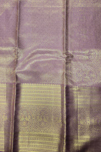 Purple fabric with gold patterns and a button