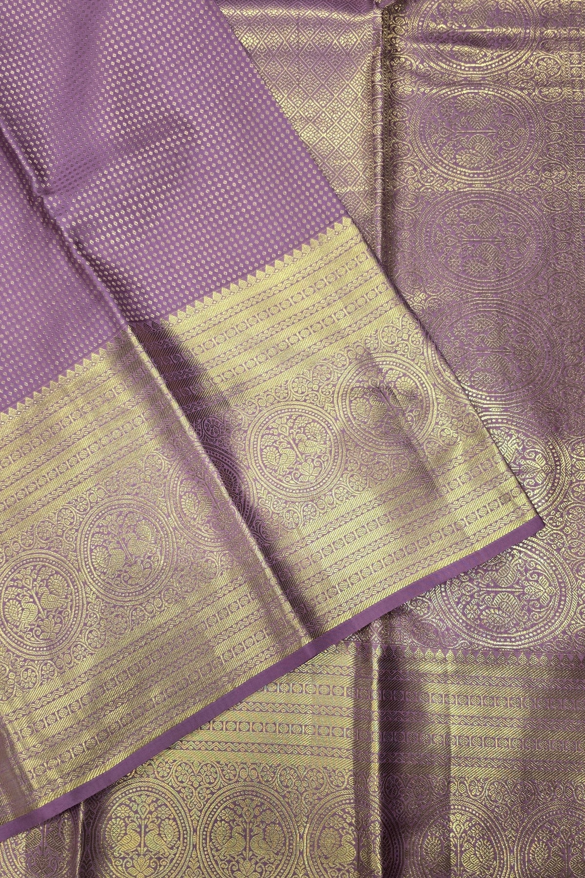 Purple and gold saree with intricate patterns