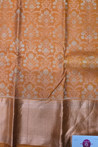 Brown fabric with floral patterns and a visible brand label in the corner.