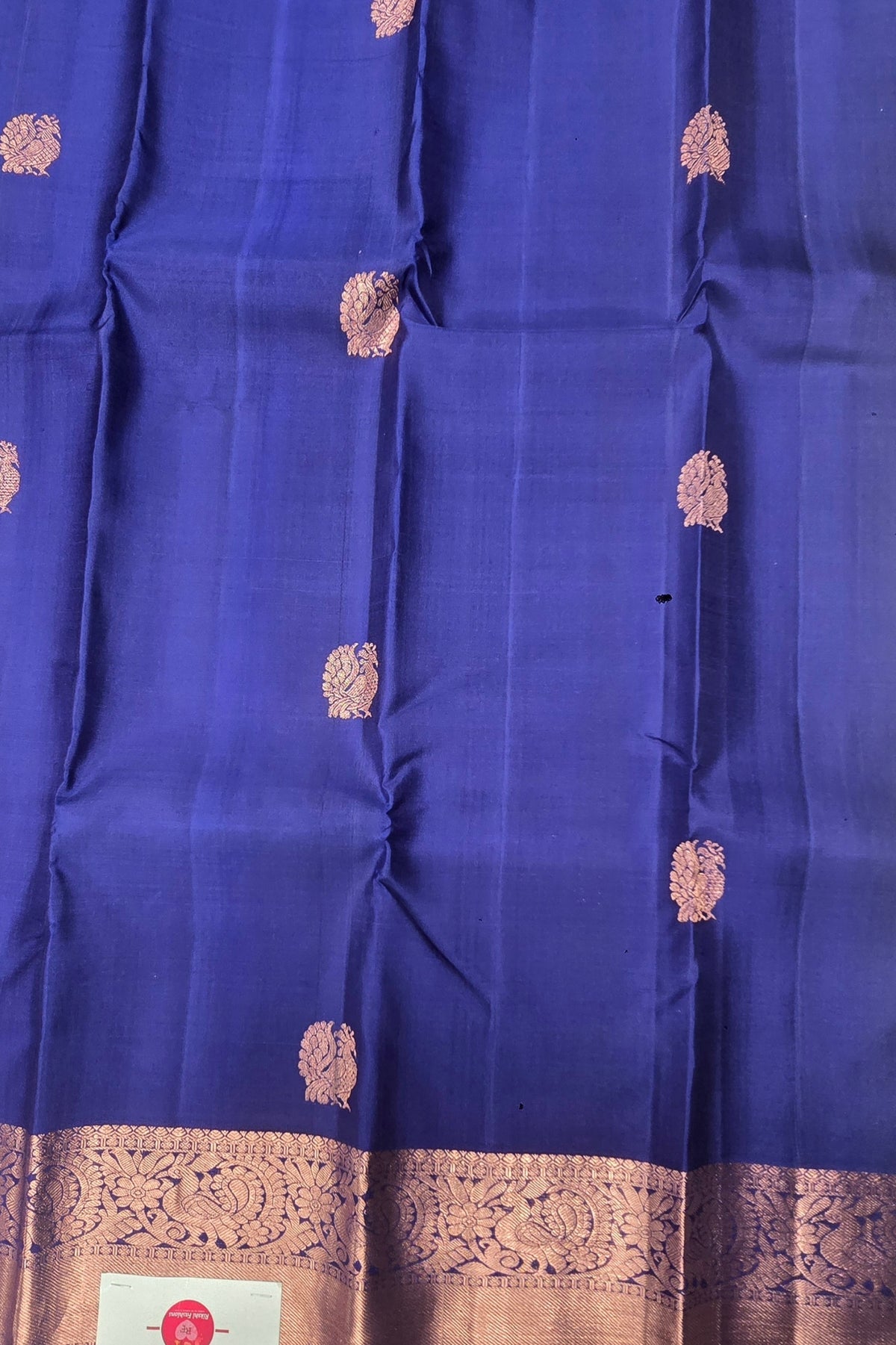 Blue fabric with gold embroidery and border