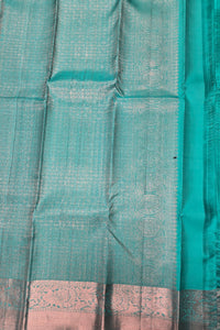 Close-up of a teal fabric with a subtle pattern