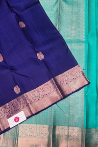 Blue saree with gold border and green fabric underneath
