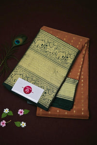 Brown and green patterned fabric with a card on a dark brown background