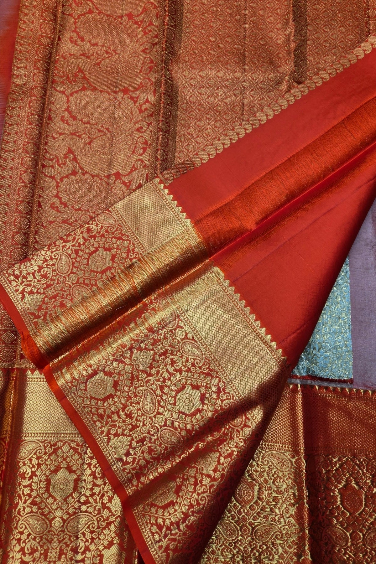 Red and gold patterned fabric with intricate designs