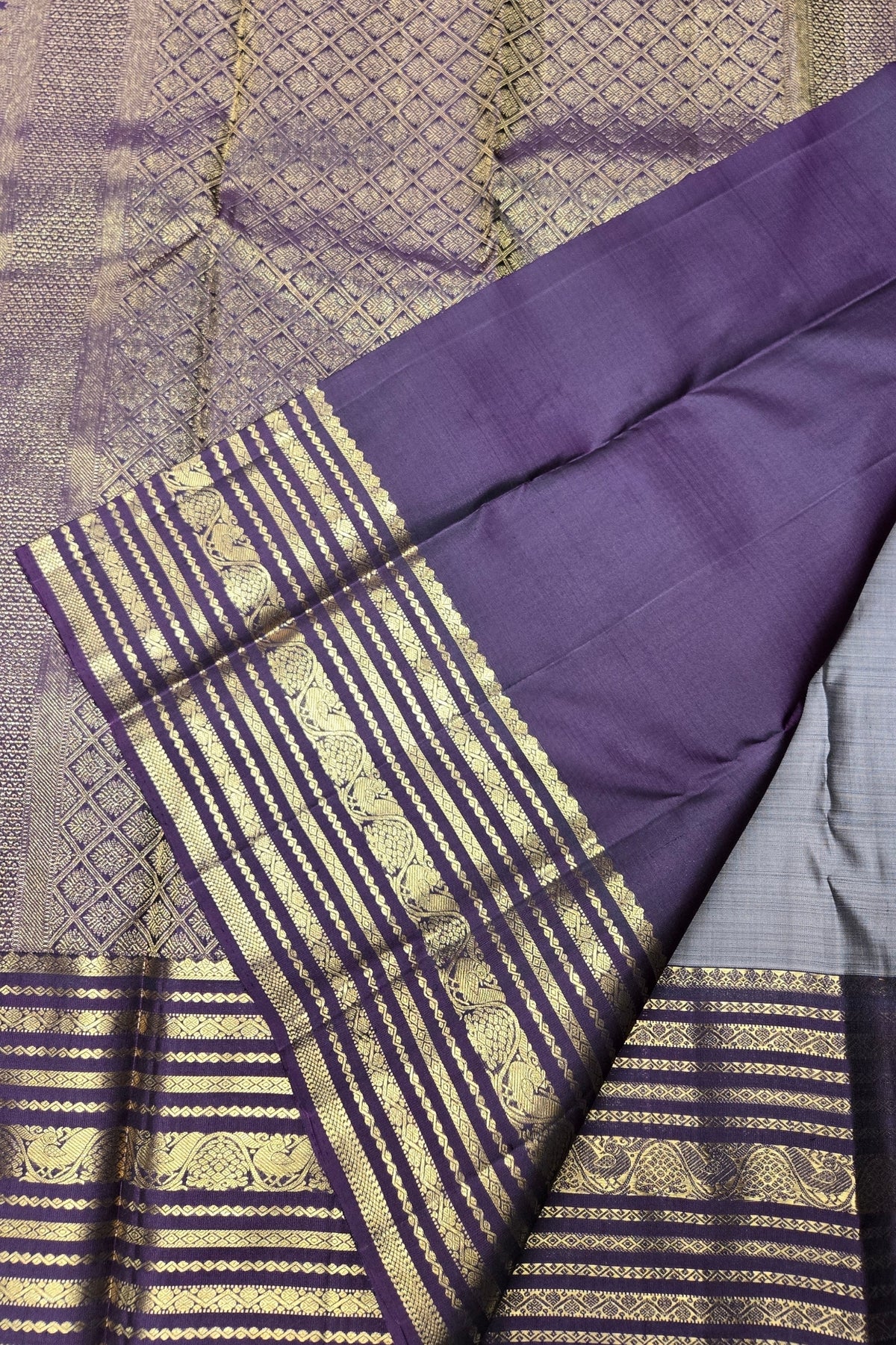 Purple fabric with gold patterns on a textured background