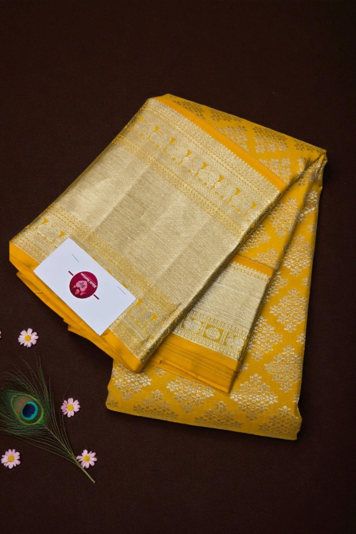 Yellow saree with intricate patterns on a brown background
