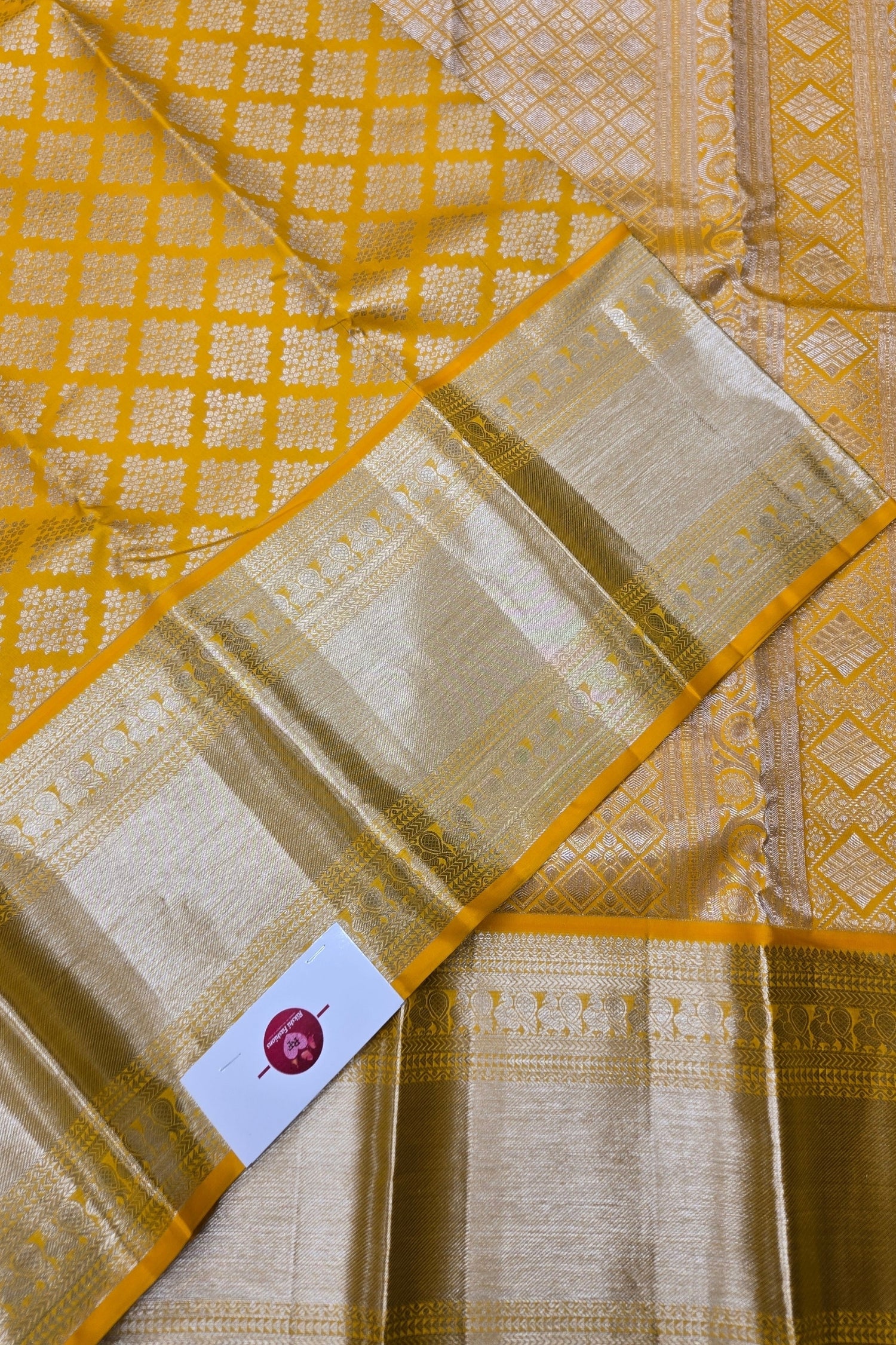 Yellow and beige saree with a visible brand label
