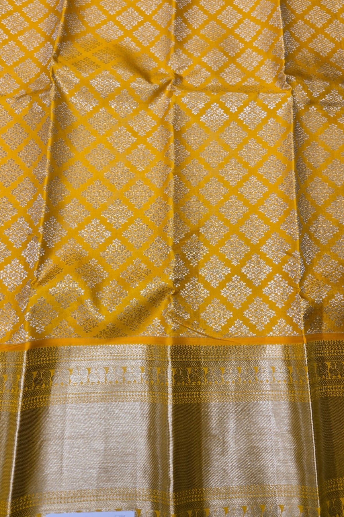 Yellow fabric with a diamond pattern and border