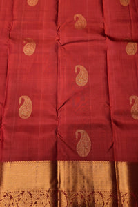 Red fabric with gold paisley patterns and border