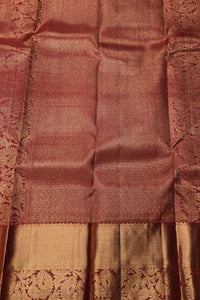 Close-up of a brown and gold saree with intricate patterns