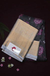 Two scarves, one beige and one black with floral pattern, on a dark background.