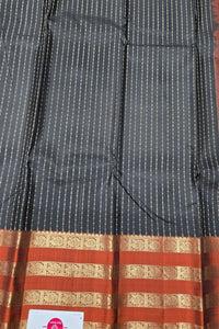 Black and red patterned fabric with a visible brand label.