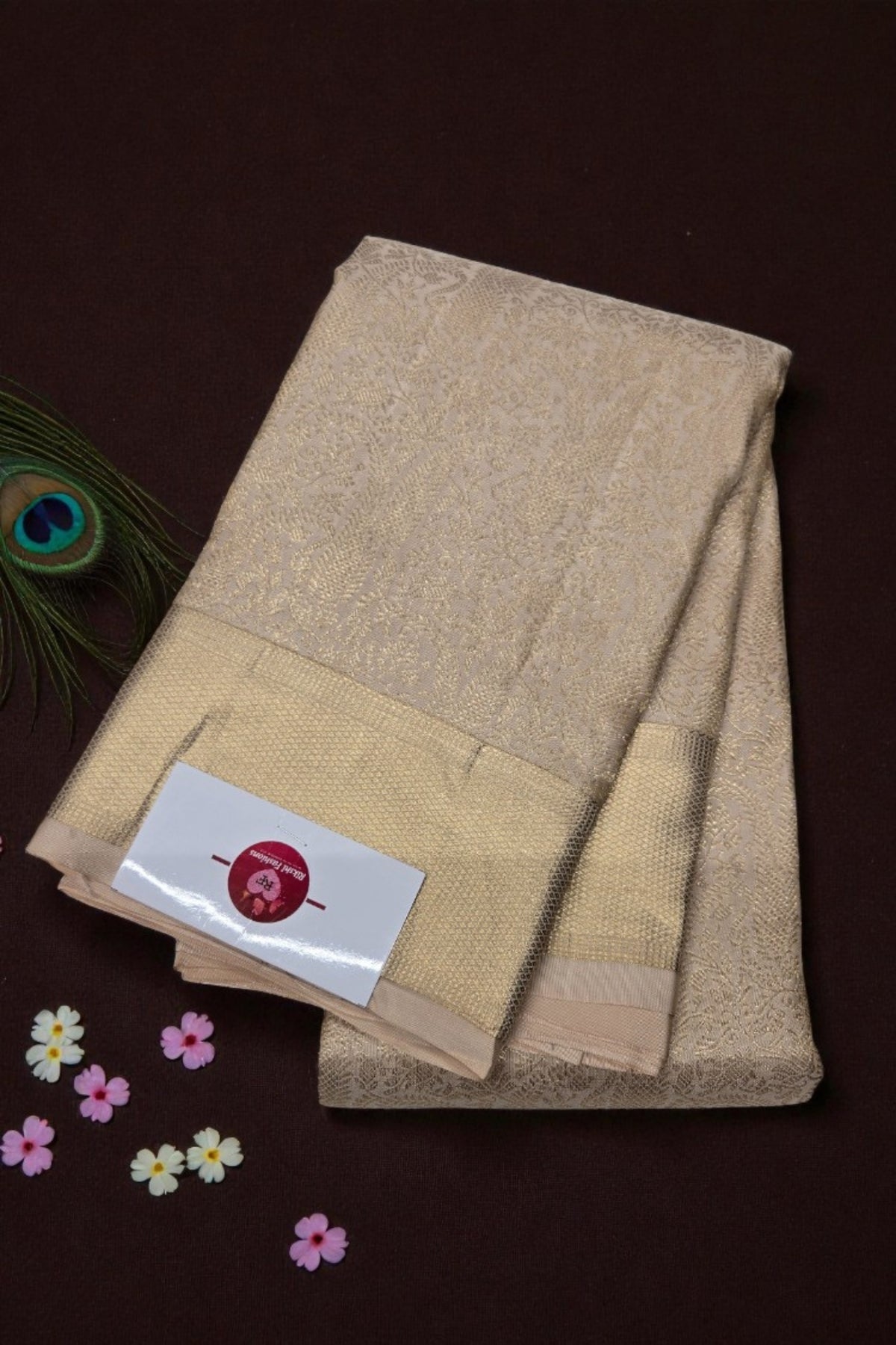 Beige towel with a brand label on a dark brown background