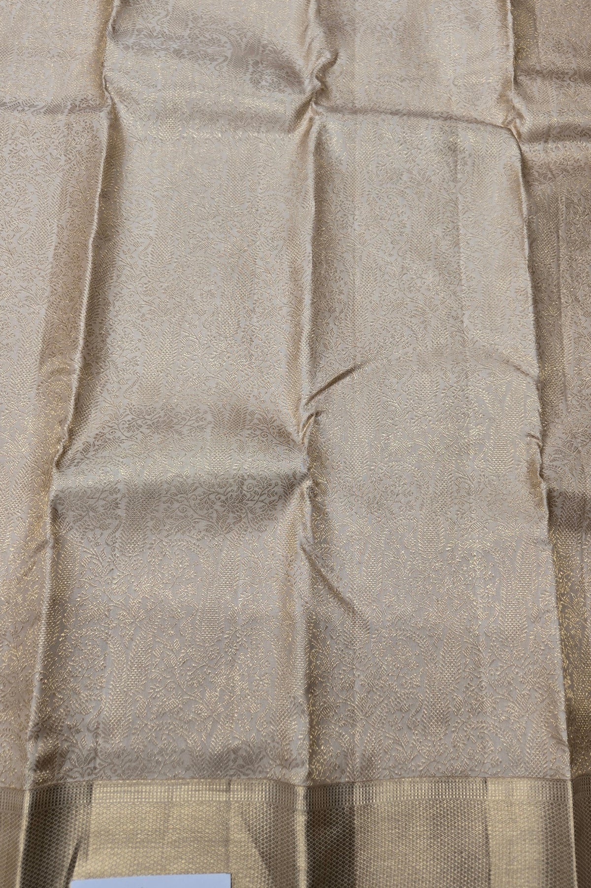 Close-up of beige fabric with a subtle pattern