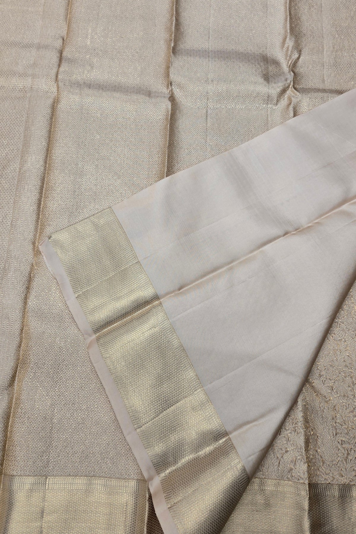 Close-up of a fabric with a gold border on a beige background