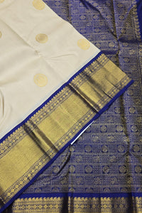 White fabric with gold patterns and blue border