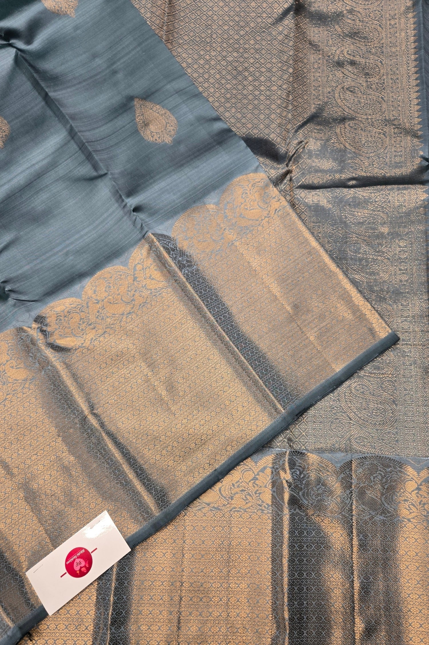 Textured fabric with a pattern and a visible brand label.