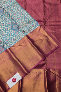 Close-up of a fabric with a patterned section and a maroon background.