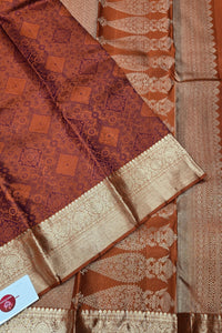 Brown and gold patterned fabric with a visible brand label.