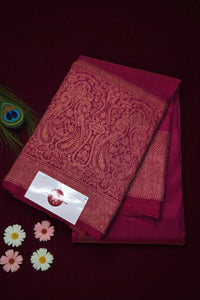 Red saree with intricate patterns on a dark background