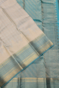 Beige and blue saree with intricate patterns