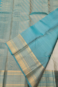 Blue and white fabric with gold border on a textured background