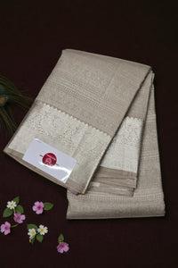 Folded beige fabric with lace details on a dark background