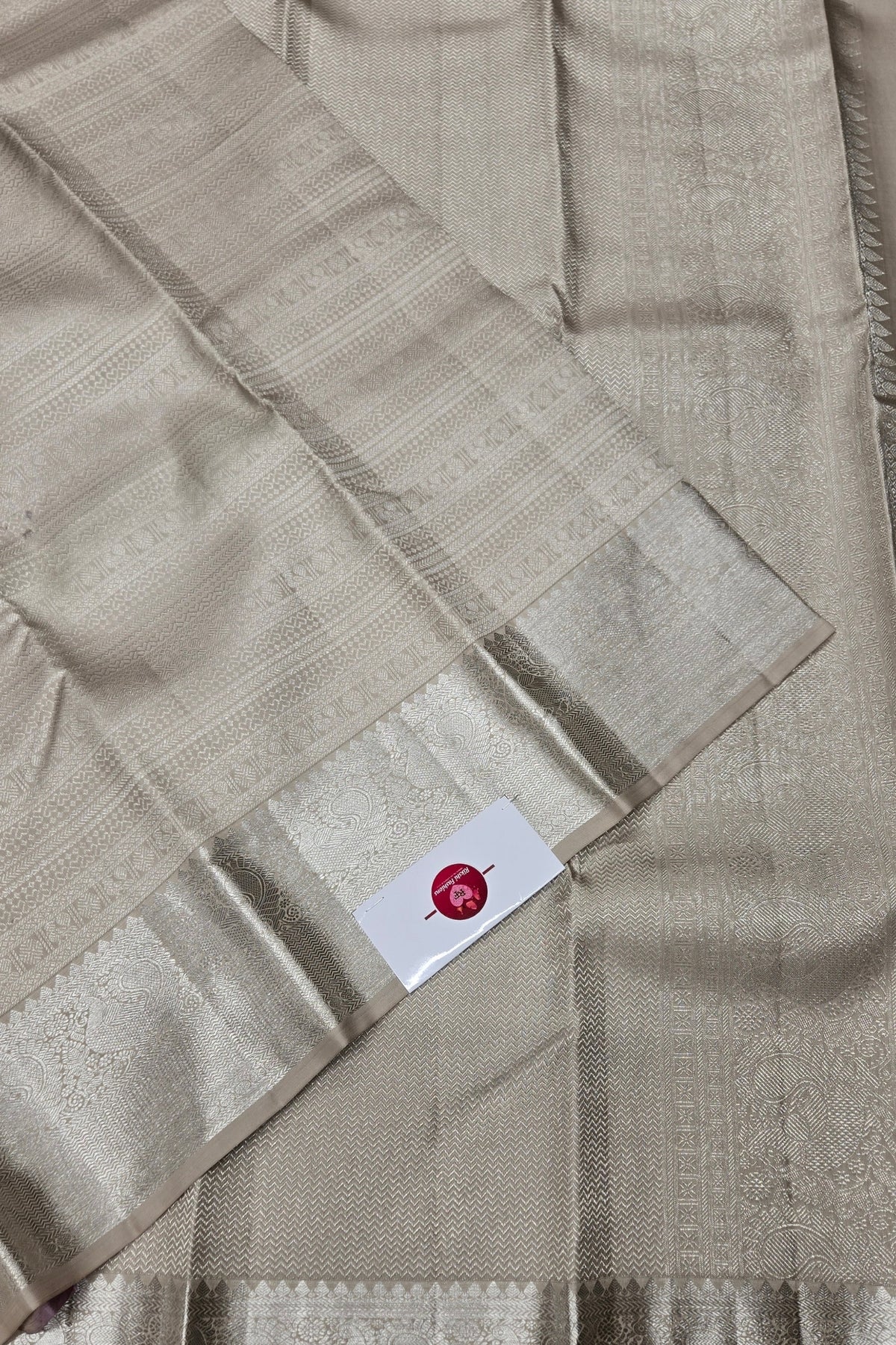 Beige fabric with a brand label on a beige background