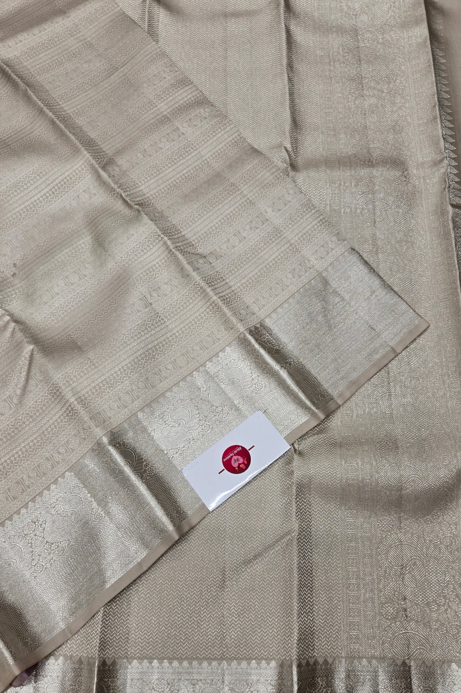 Beige fabric with a brand label on a beige background