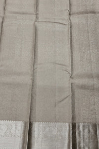 Close-up of a gray saree with a woven pattern